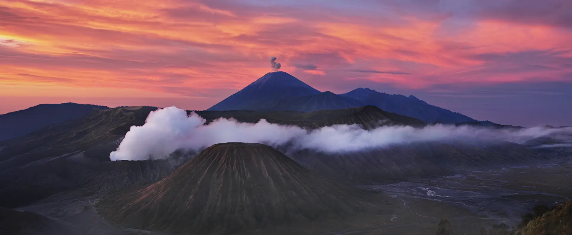 Fiery sunrise panorama over Mount Bromo volcanic complex